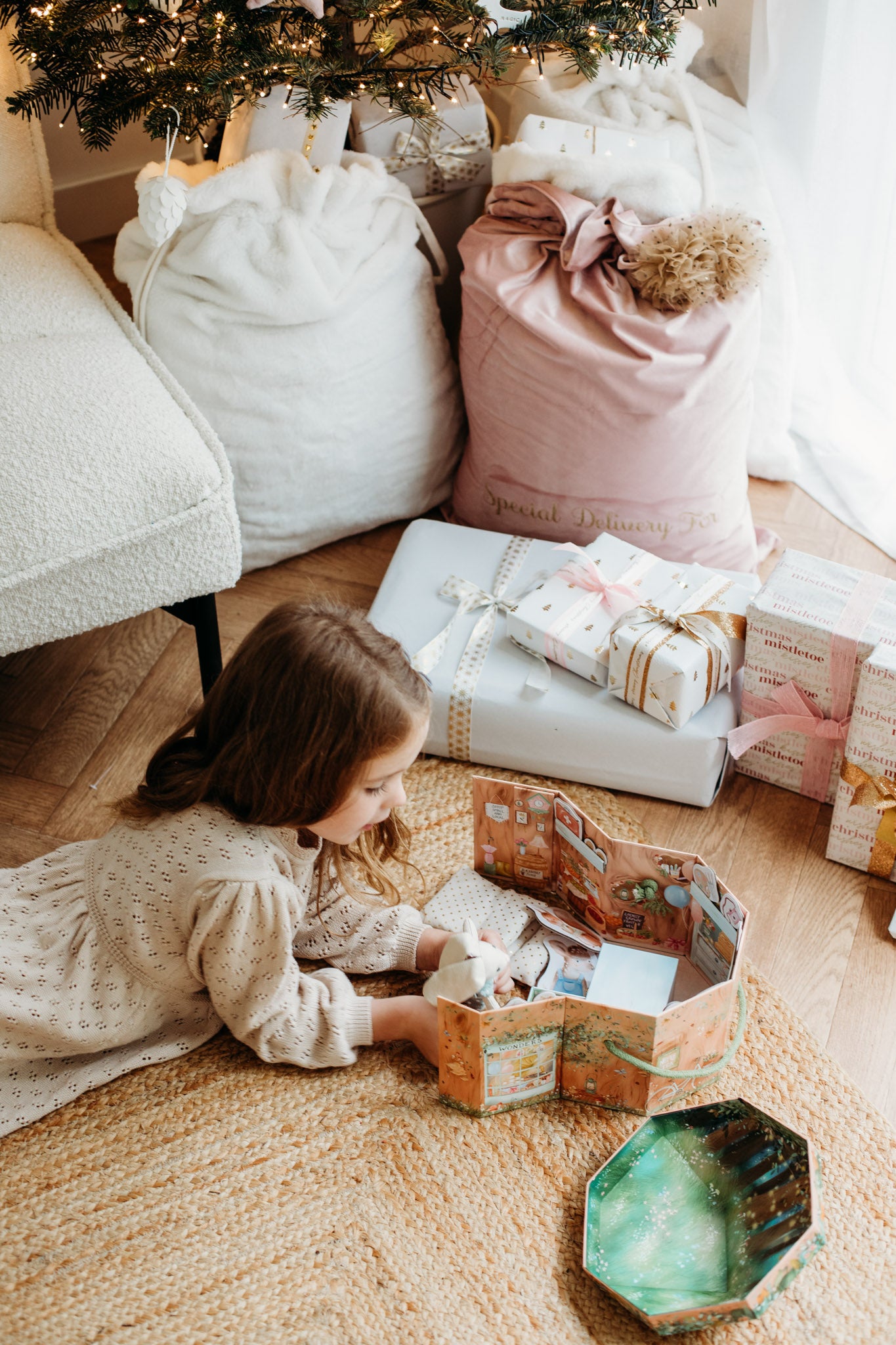 Girl playing with woodland wonders set on Christmas morning.