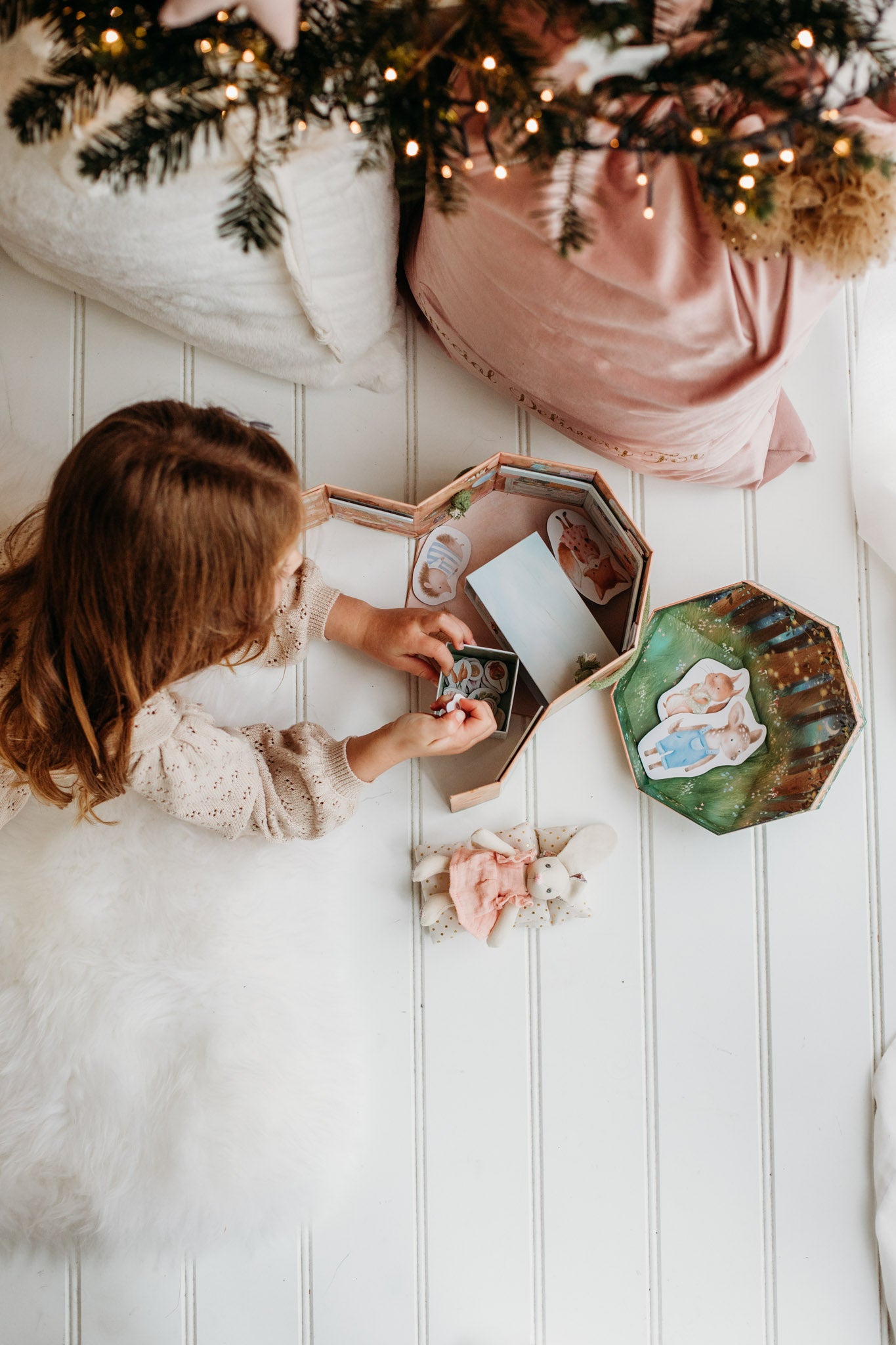 Girl playing with woodland wonders play set.