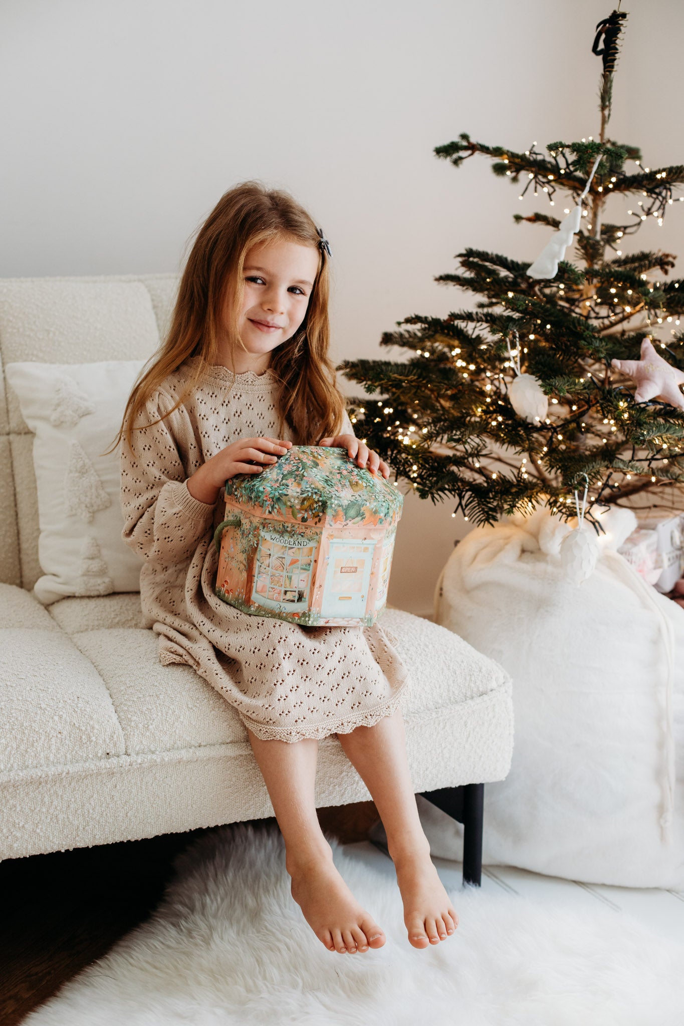 Girl with the woodland wonders set sat on a chair.