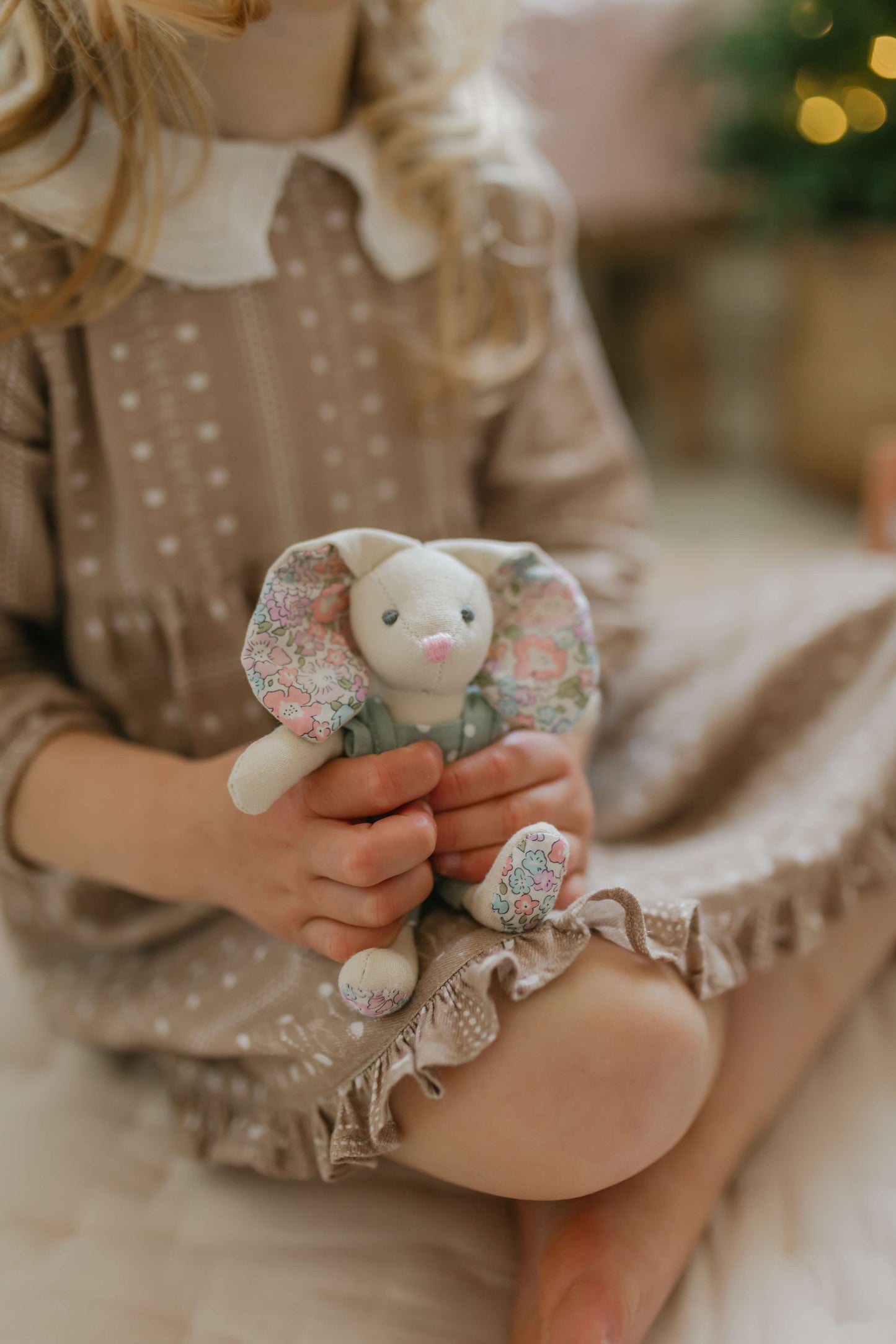 Child holding Betsy Bunny from the Woodland Wonders children's playset.